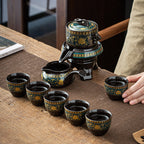 Ceramic tea set with teapot and cups on a wooden table